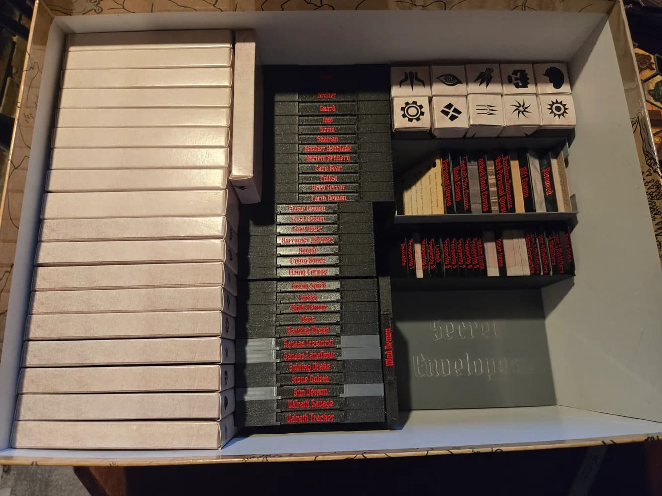 Inside the Gloomhaven box with monsters and components sorted into a 3D-printed insert